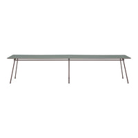 Long rectangular glass table with a sleek, clear top and minimalist dark brown legs. Modern design with a clean aesthetic.