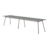 Long rectangular tabletop in muted green with sleek metal legs, featuring a minimalist design and no visible patterns.