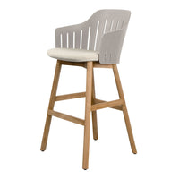 Light gray bar stool with a slatted back and cream cushion, featuring natural wooden legs for a stylish, modern look.