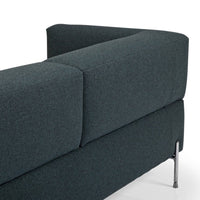 Dark teal upholstered sofa with a sleek, modern design and smooth texture. Features minimalist lines and a contemporary look.
