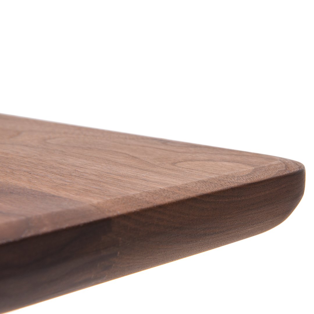 Wooden tabletop edge with rich dark walnut finish, smooth texture and subtle grain patterns. Perfect for modern decor.