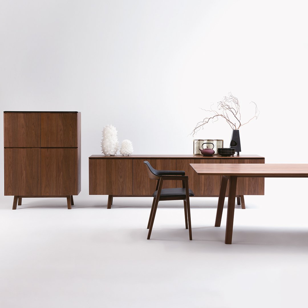 "Modern walnut furniture set featuring sleek lines and smooth surfaces in rich brown tones."