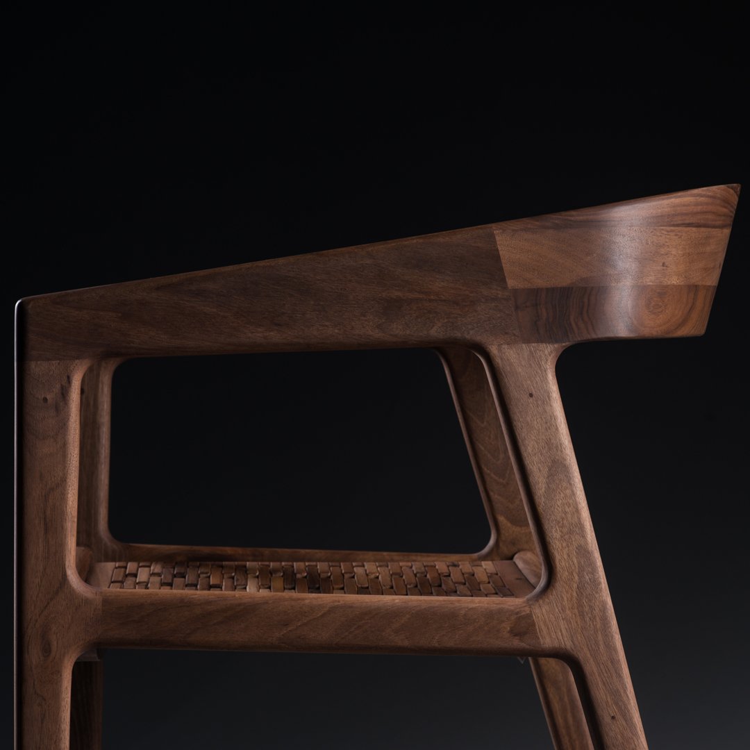 "Stylish walnut wood chair with a sleek, modern design and rich brown tones."