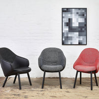 Three modern chairs in black, gray, and red, featuring sleek, smooth surfaces and textured patterns.