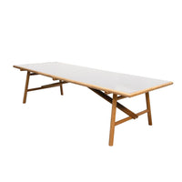 Light wood table with a sleek white surface and simple, modern design. Perfect for any home decor.