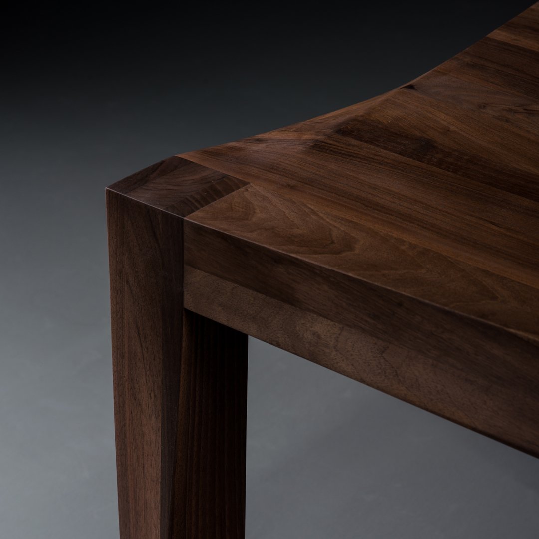 Dark wood tabletop with rich brown hues and smooth, natural grain pattern. Elegant, minimalist design.