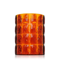 Amber glass candle holder with a textured, ribbed pattern. Features warm orange and brown hues for a cozy look.
