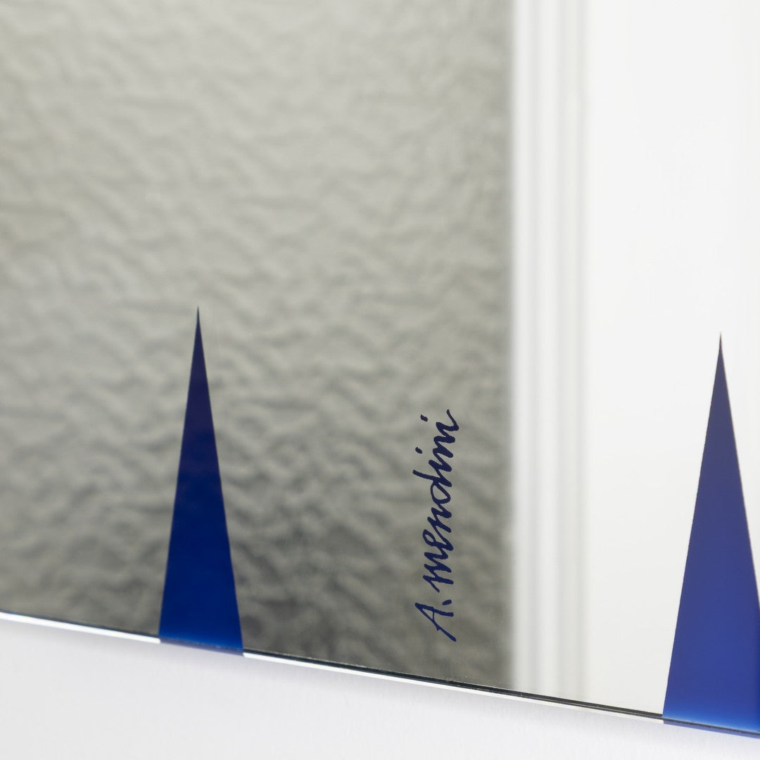 "Blue accent patterns on modern mirror with textured background, featuring unique design elements."