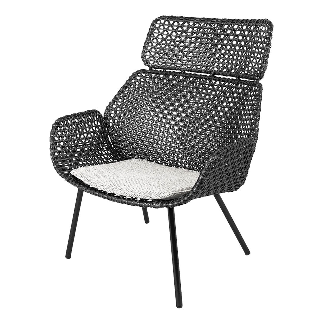 Black woven chair with a patterned backrest and contrasting white seat cushion, perfect for modern decor.