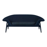 Dark navy blue modern sofa with sleek lines and a simple, minimalist design. Featuring a smooth texture.