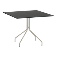 Black square table with a sleek, minimalist design and a light gray metal base. Ideal for modern decor.