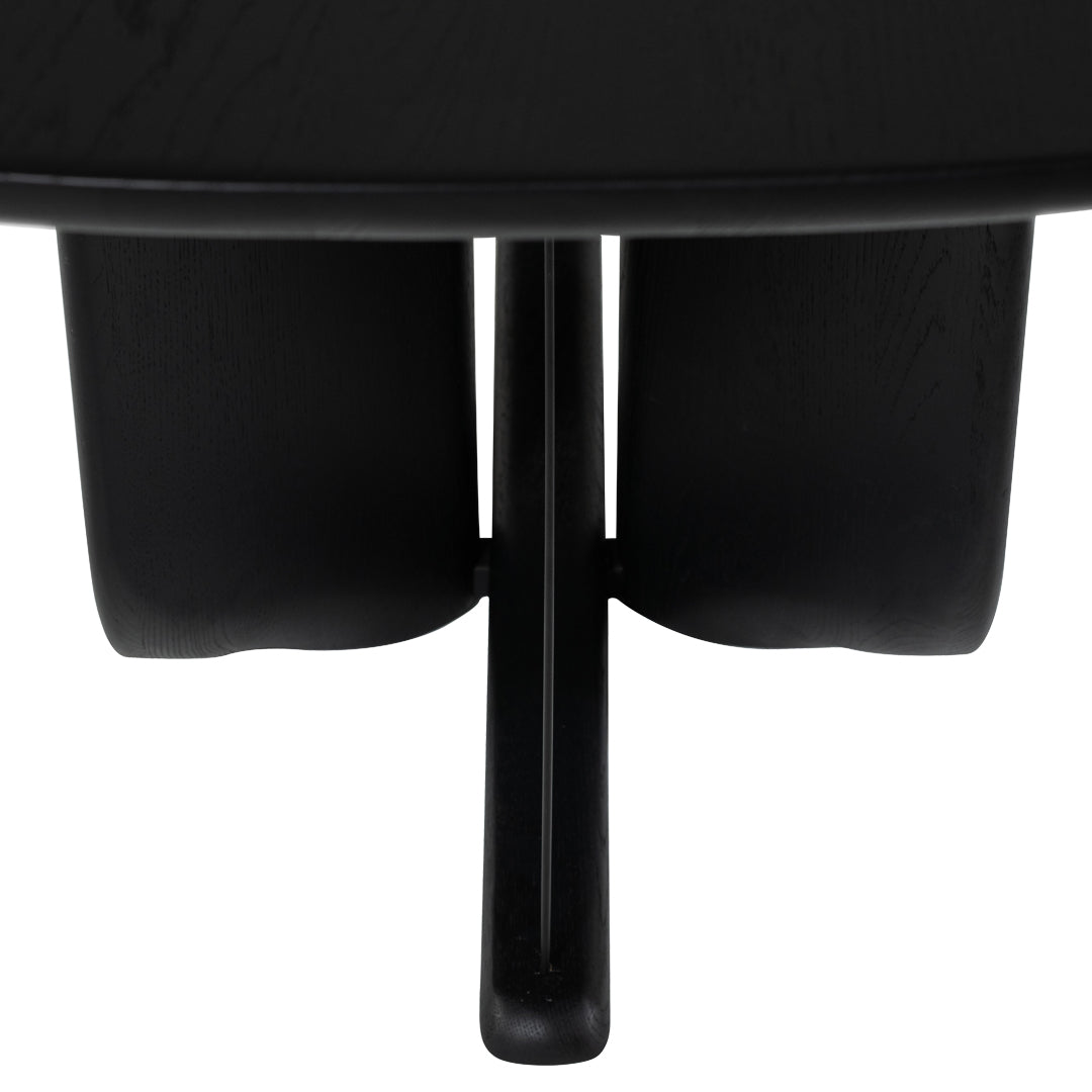 Black wooden table with a sleek, minimalistic design and smooth, curved edges. Elegant and modern aesthetic.