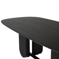 Black oval dining table with smooth finish and intricate wood grain pattern. Modern design for contemporary spaces.