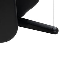 "Close-up of sleek black curves and lines, showcasing a modern minimalist design."