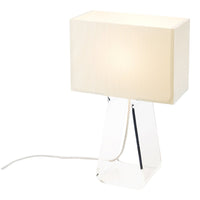 Minimalist white lamp with a sleek, clear base and soft, rectangular fabric shade creating an elegant look.