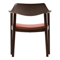 Brown wooden chair with a curved back and a smooth orange seat, showcasing a modern, minimalistic design.