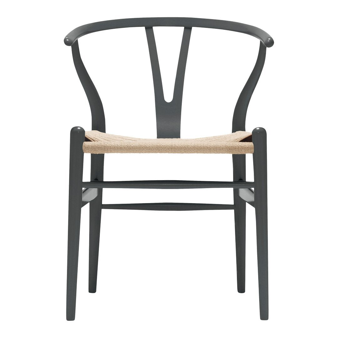 Black wooden chair with a minimalist design and natural woven seat, showcasing elegant curves and clean lines.