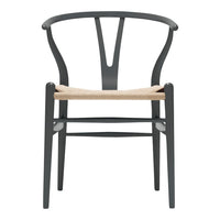 Black wooden chair with a minimalist design and natural woven seat, showcasing elegant curves and clean lines.