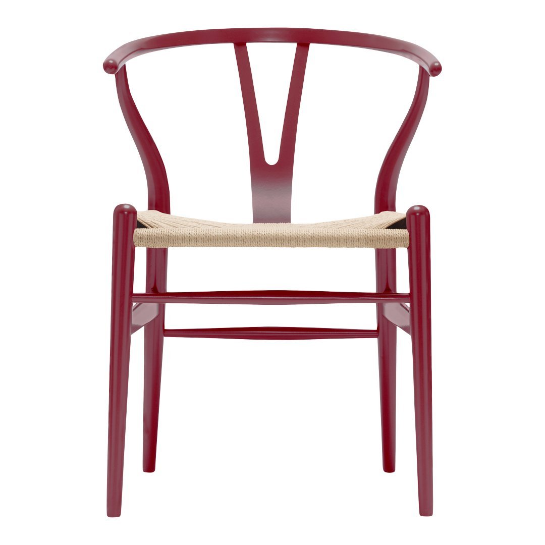 Red wooden chair with a distinctive Y-shaped back and natural woven seat, adding a modern touch to any space.