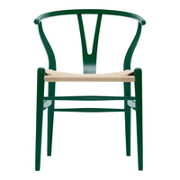 Green wooden chair with a sleek design and natural woven seat, showcasing a minimalist style.