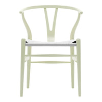 Light green chair with a minimalist design and a white seat, featuring a smooth surface and curved backrest.