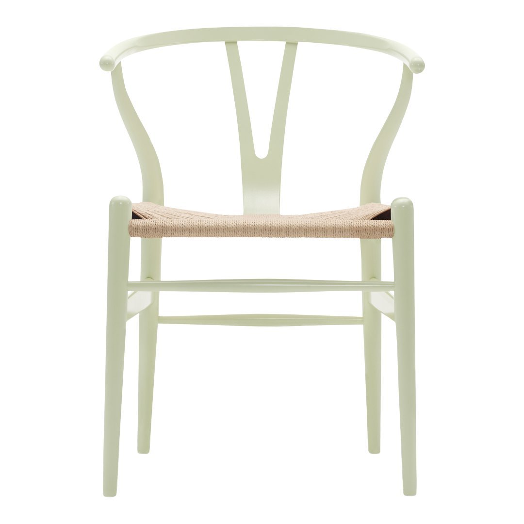 Pale green chair with a woven natural fiber seat, featuring a modern design and minimalist style.