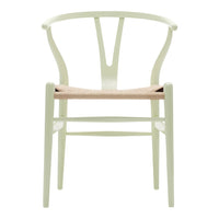 Pale green chair with a woven natural fiber seat, featuring a modern design and minimalist style.