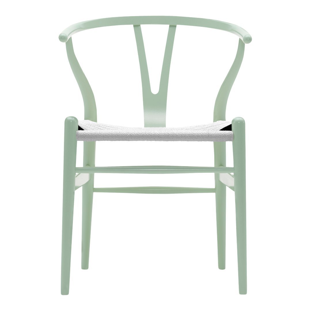 Light mint green wooden chair with a minimalist design and white seating, featuring a curved back and clean lines.