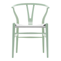 Light mint green wooden chair with a minimalist design and white seating, featuring a curved back and clean lines.