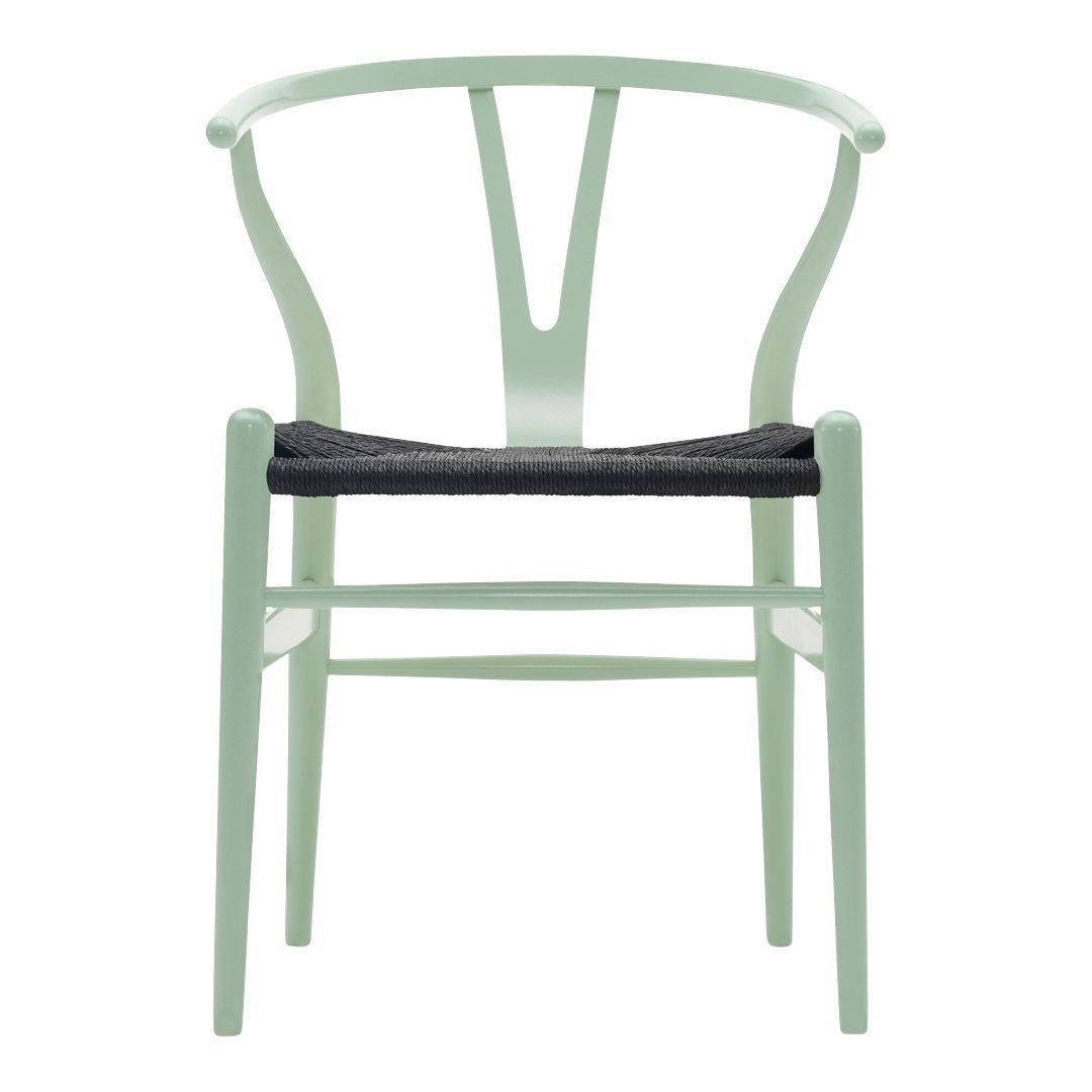 Mint green chair with a minimalist design and dark woven seat. Modern color combination for stylish decor.
