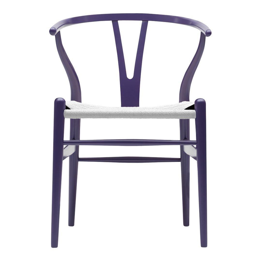 Purple chair with a unique Y-shaped back and neutral woven seat, showcasing modern design and vibrant color.