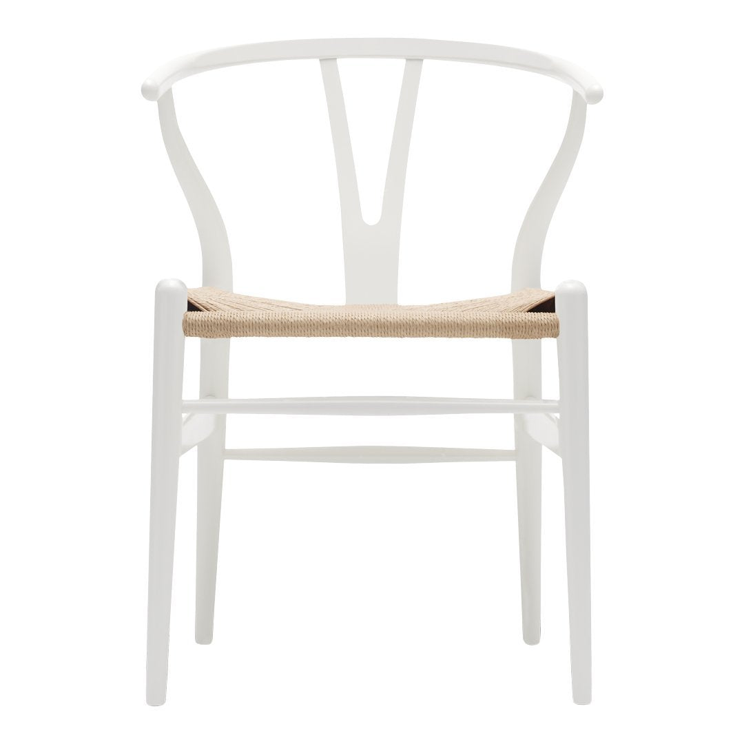 White wooden chair with a woven natural seat and a minimalist design. Clean lines and neutral tones ideal for modern decor.