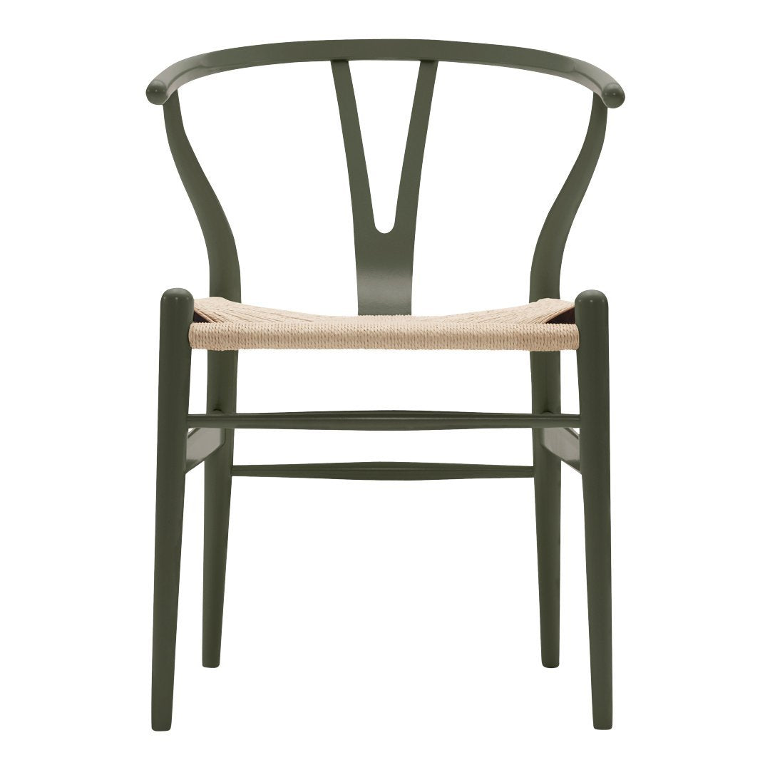 Green wooden chair with a woven natural seat and minimalist design. Elegant curves and clean lines enhance modern decor.