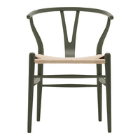 Green wooden chair with a woven natural seat and minimalist design. Elegant curves and clean lines enhance modern decor.
