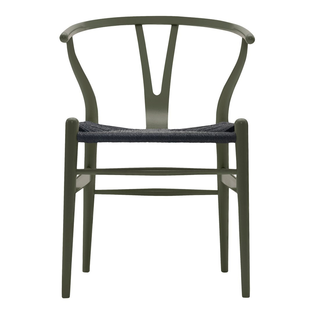 Olive green dining chair with a woven black seat, featuring a minimalist design and elegant curves.