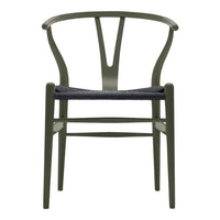 Olive green dining chair with a woven black seat, featuring a minimalist design and elegant curves.