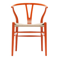 Vibrant orange wooden chair with a woven beige seat and elegant curvy design. Perfect for modern decor.