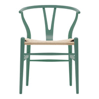 Green wooden chair with a woven natural fiber seat and minimalist design. Perfect for modern decor.