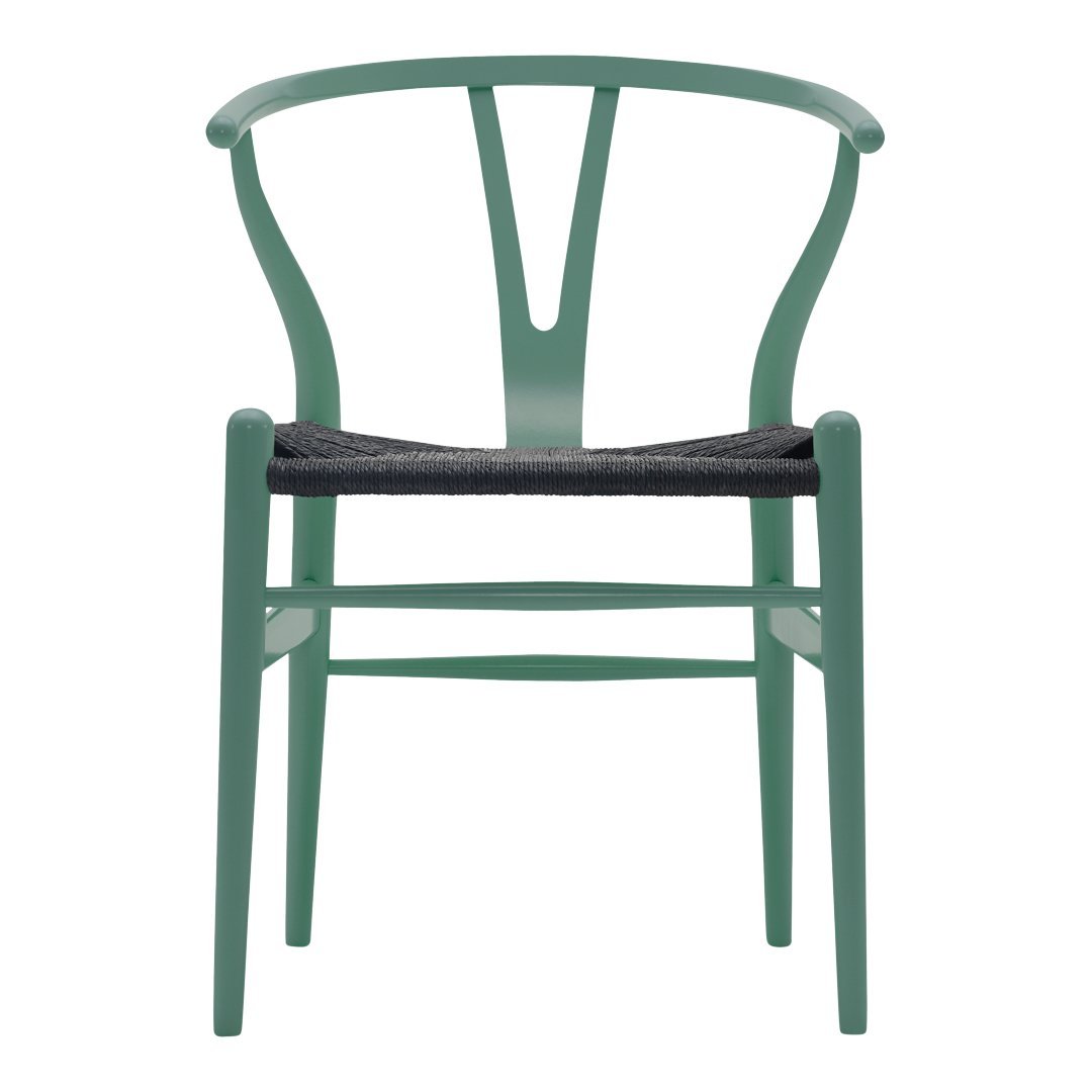Mint green wooden chair with a woven black seat, featuring a unique, modern curved design.