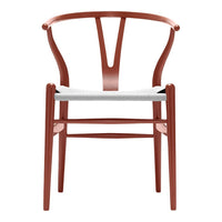 Rust-colored wooden chair with a sleek, minimalistic design and a white woven seat. Perfect for modern interiors.