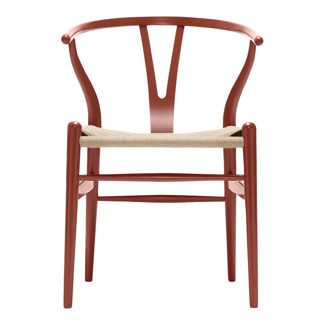 Rust red wooden chair with a woven natural fiber seat and a minimalist design. Perfect for modern decor.