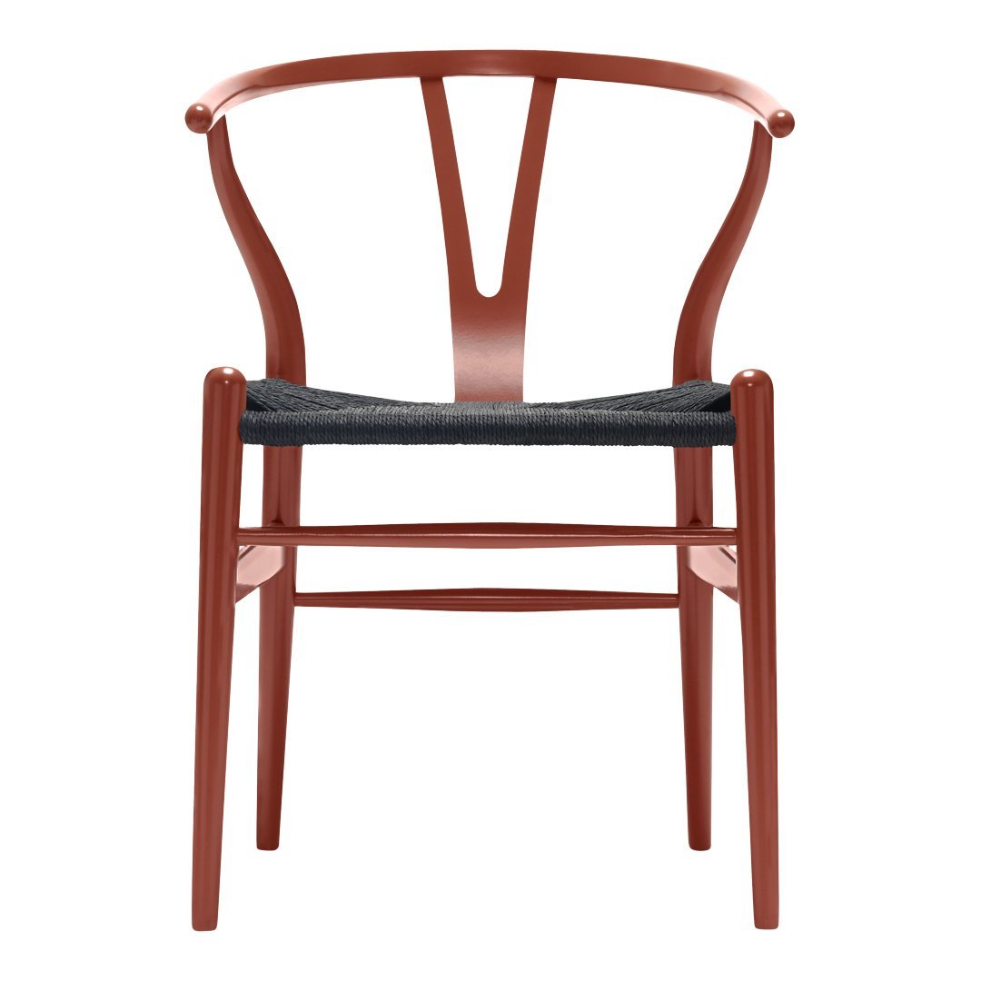 Modern chair in warm red with a textured black seat, featuring a sleek, minimalistic design and unique back pattern.