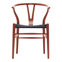 Modern chair in warm red with a textured black seat, featuring a sleek, minimalistic design and unique back pattern.