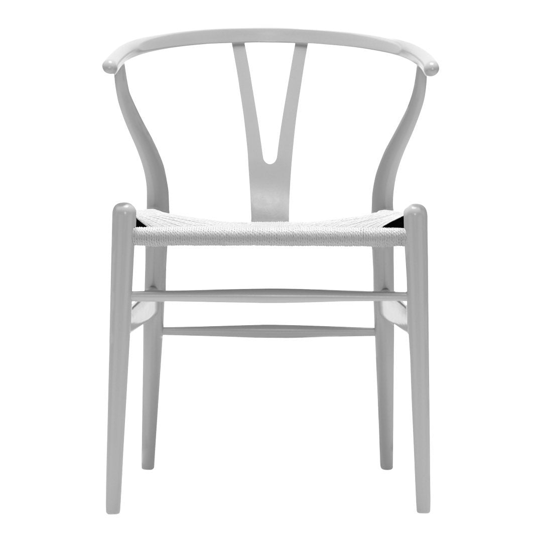 White wooden chair with a minimalist design and a smooth, matte finish. Elegant, curved backrest and woven seat pattern.