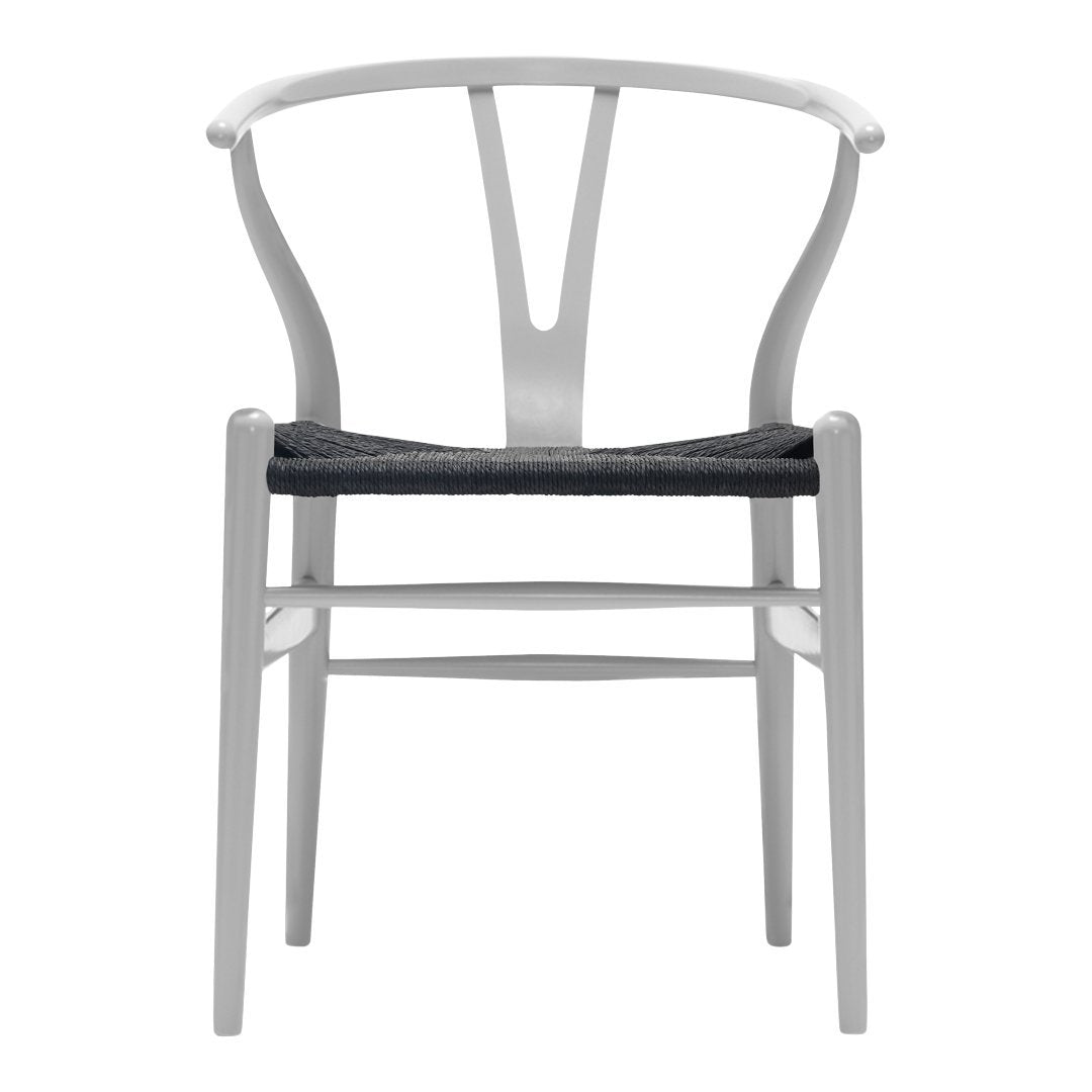 White wooden chair with a curved backrest and a dark gray woven seat. Simple, modern design.