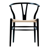 Black wooden chair with a minimalist design and natural woven seat. Elegant curves and modern styling.