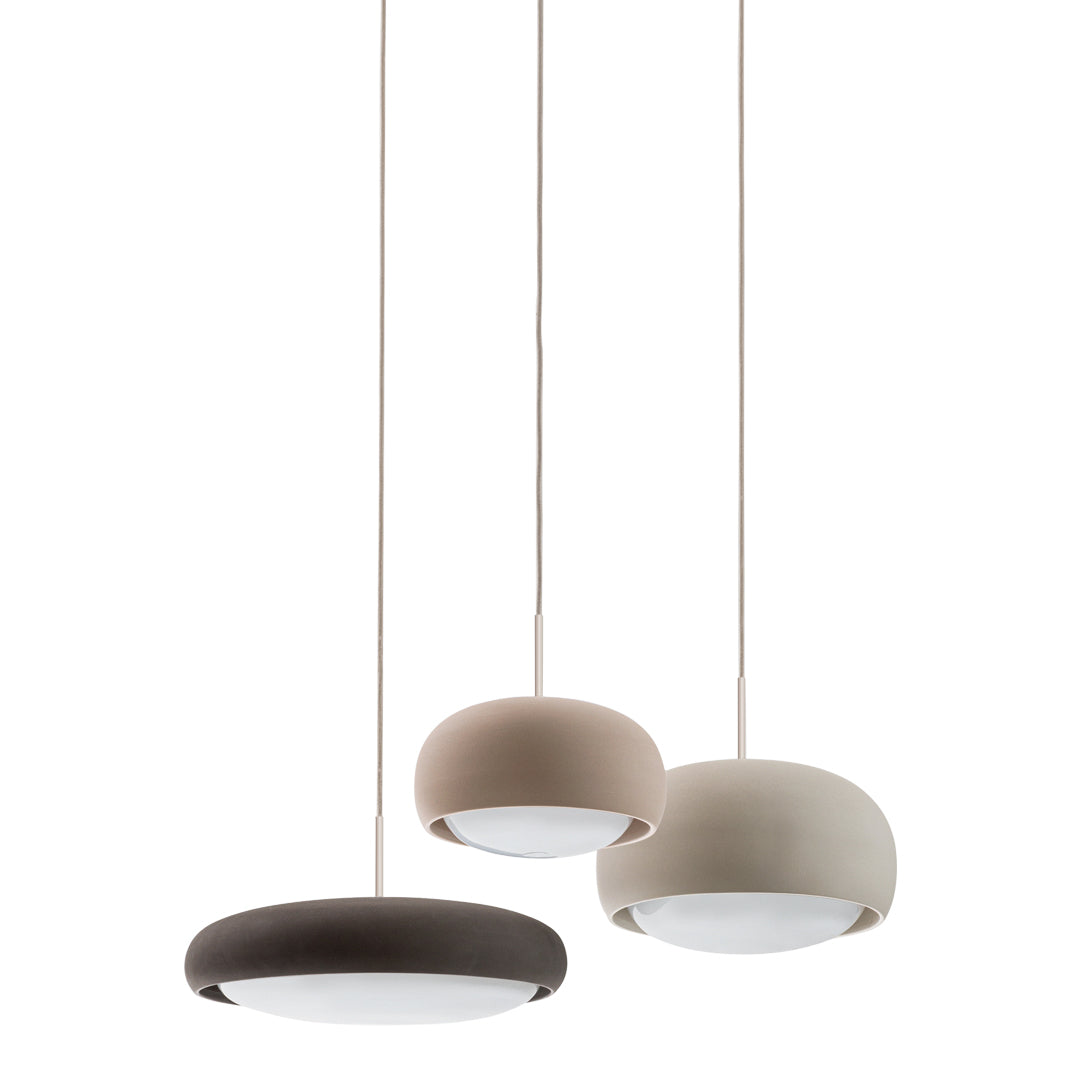 Three pendant lamps in beige, light brown, and dark brown with a sleek, circular design. Modern and minimalistic style.