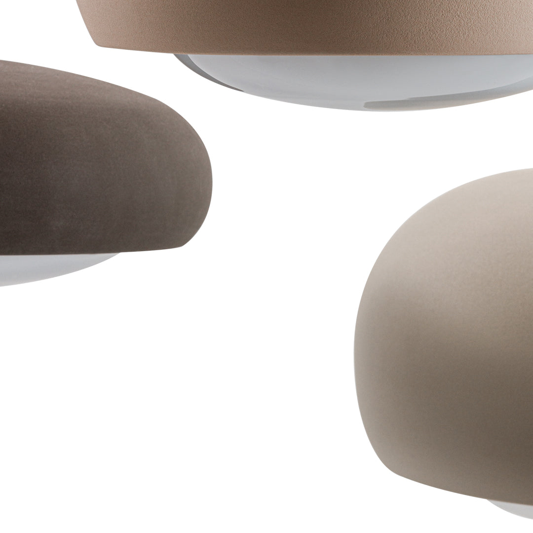 Three modern lamps featuring soft taupe, brown, and beige shades with smooth, curved designs.