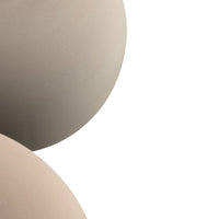 "Two smooth, rounded surfaces in soft beige and earthy taupe tones, showcasing subtle color variation."