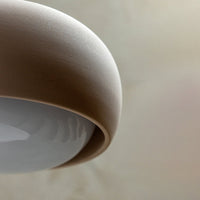 Neutral beige and soft white lamp design with a smooth, rounded shape and minimalist aesthetic.